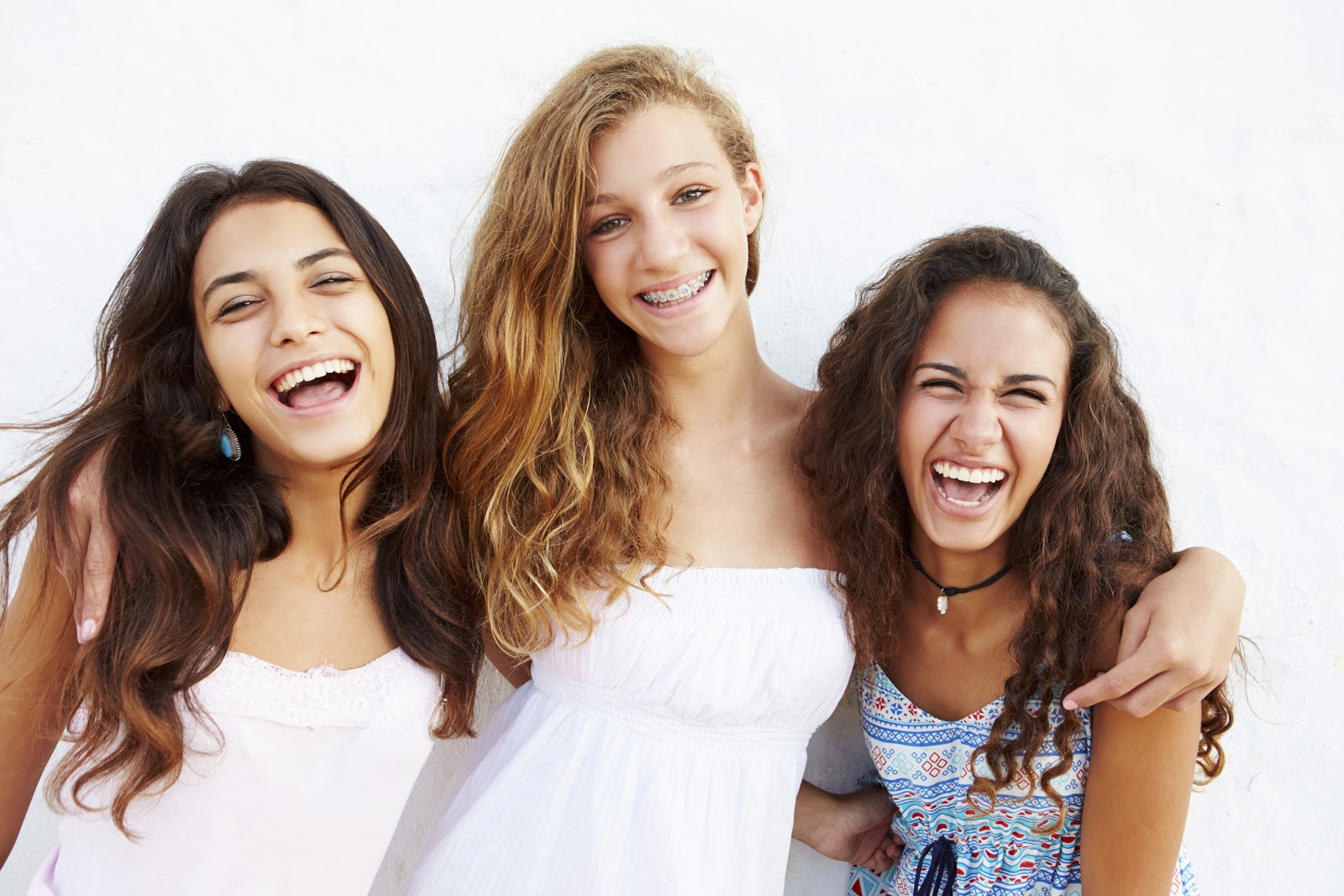 group of friends laughing with braces